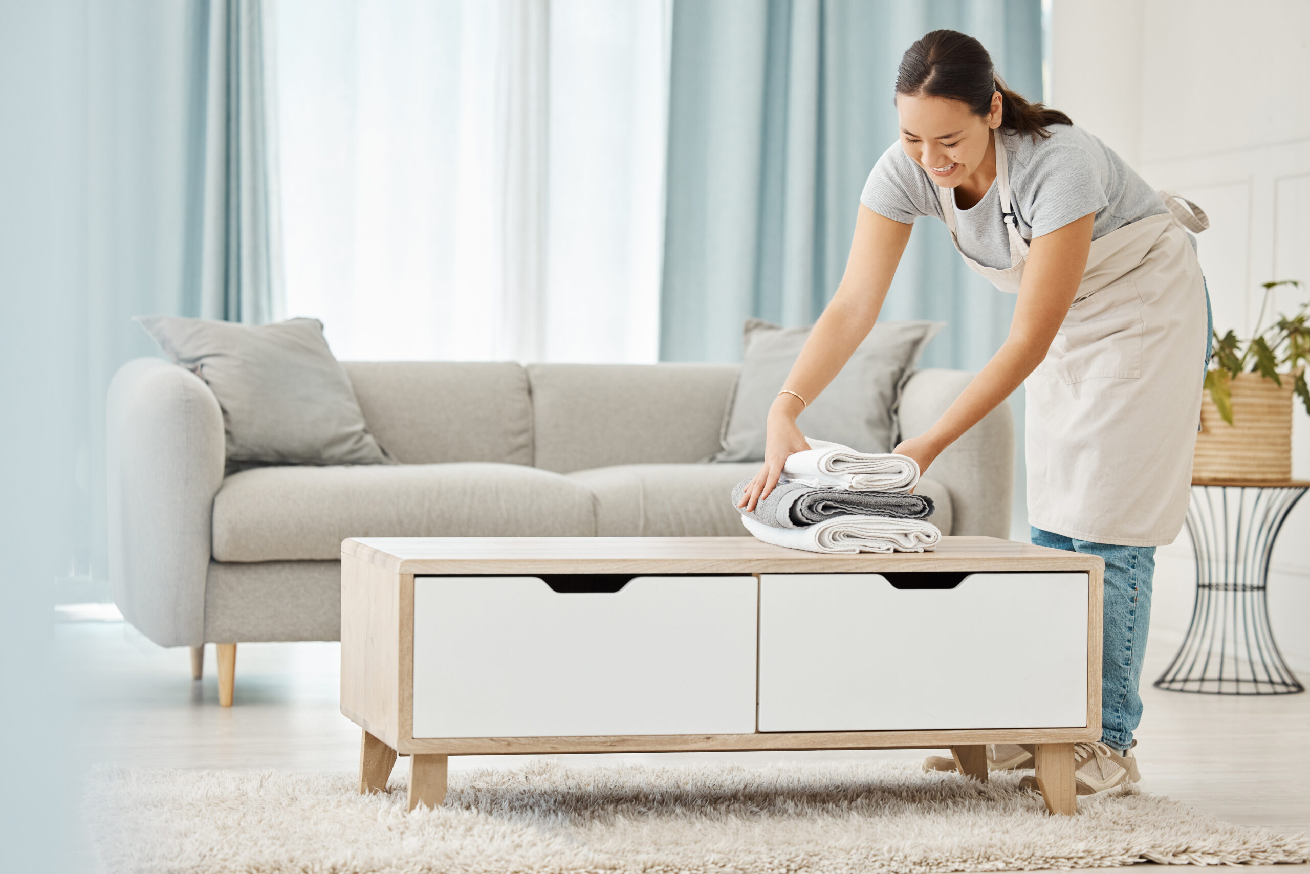 Asian cleaner or woman with towel laundry happy working for luxury hospitality hotel, home or house cleaning service agency. Japanese girl maid, employee or worker smile and help at rich apartment.